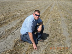 Mace Bauer inspects the conditions in a freshly planted peanut field. As daily high temperatures increase, conditions are optimum for planting of crops. 
